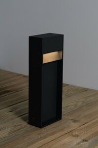 The Positano 3.2W 400mm LED Bollard turned on, demonstrating that it has a warm light.